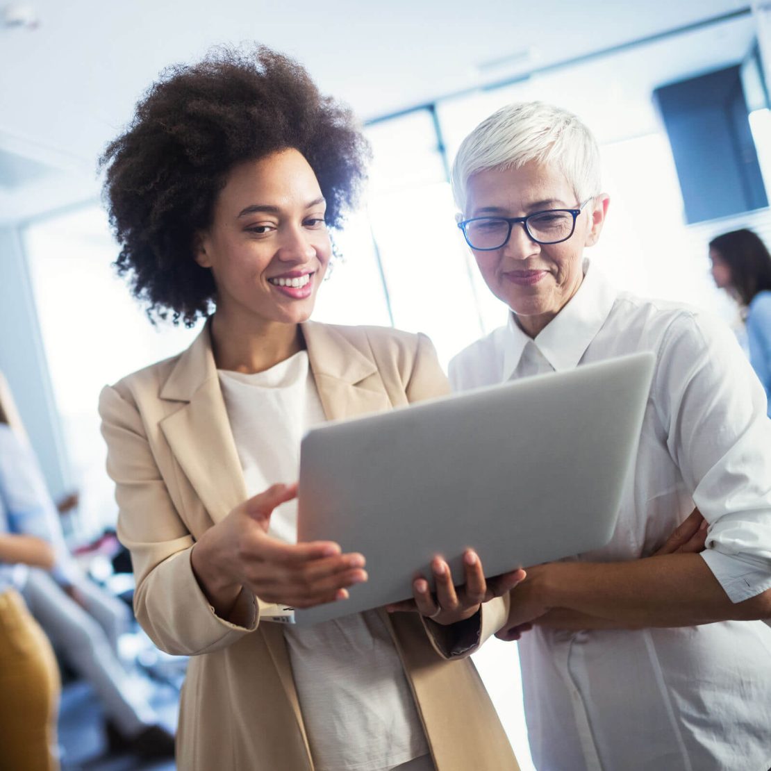 Two women looking at a laptop